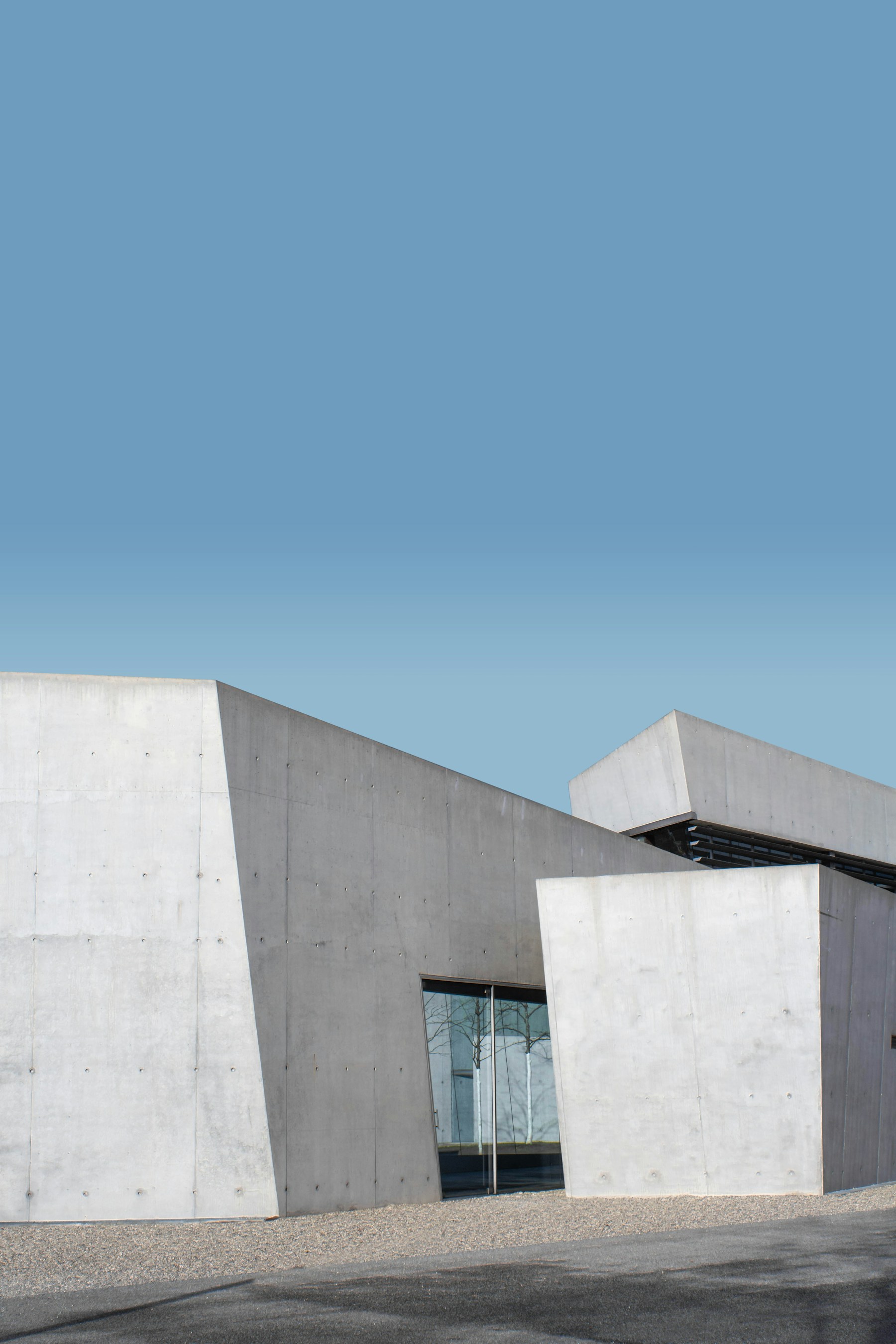 Sculptural concrete architecture against a clear blue sky
